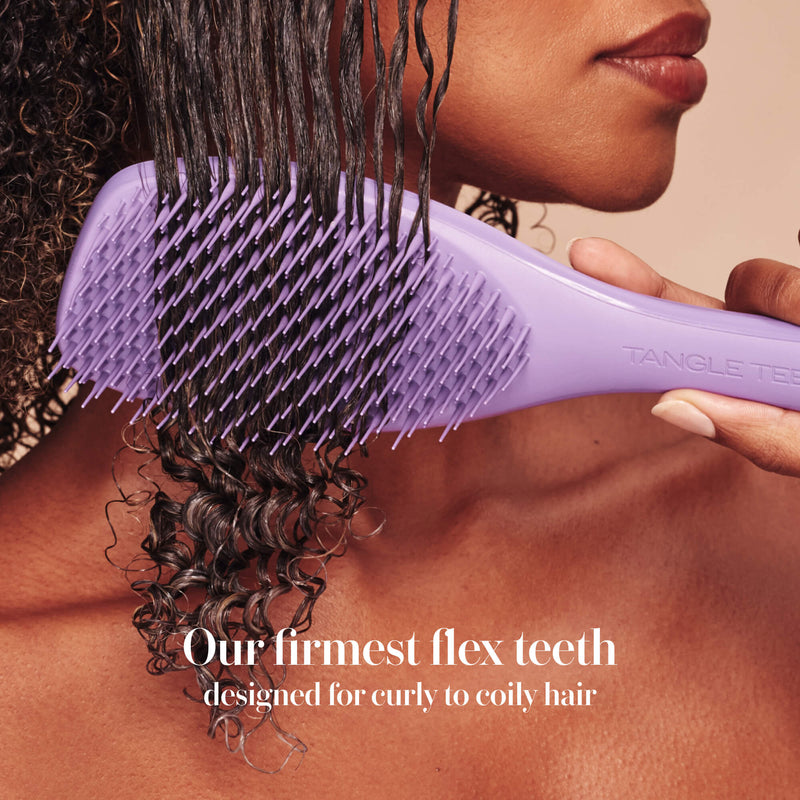 Model styling hair with the Tangle Teezer Complete Carebrush in Velvet Purple