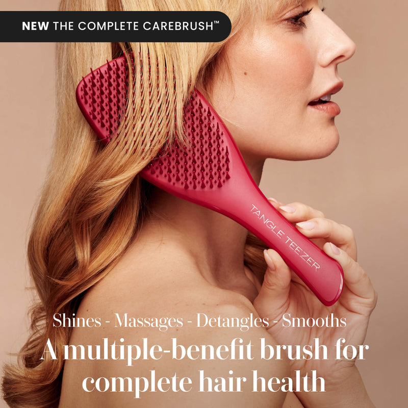 Model using the Tangle Teezer Complete Carebrush in Glossed Raspberry