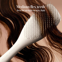 Model styling hair with the Tangle Teezer Complete Carebrush in Halo White