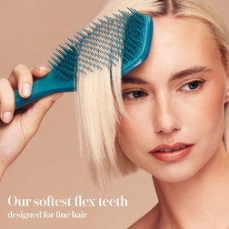 Model styling hair with the Tangle Teezer Complete Carebrush in Radiant Teal
