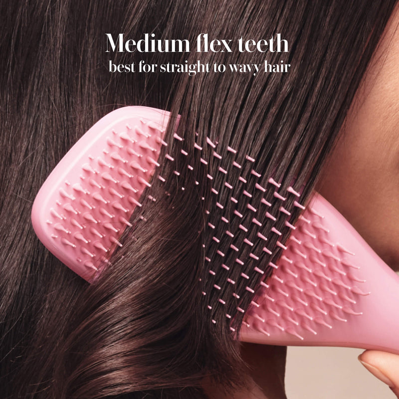 Model styling hair with the Tangle Teezer Complete Carebrush in Satin Rose