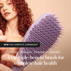 Model using the Tangle Teezer Complete Carebrush in Velvet Purple
